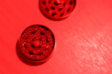 Ground medical marijuana in a grinder. Preparing for smoking. Top view of accessories for drug use.の写真素材