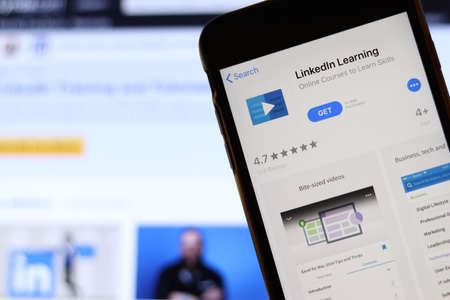 Los Angeles, California, USA - 21 November 2019: LinkedIn Learning logo on phone screen with icon on laptop on blurry background, Illustrative Editorial.のeditorial素材