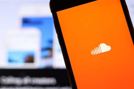 Los Angeles, California, USA - 21 November 2019: Soundcloud logo on phone screen with icon on laptop on blurry background, Illustrative Editorial.のeditorial素材