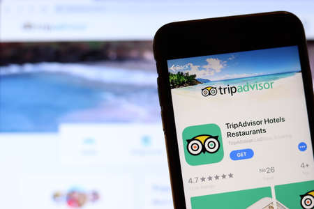 Los Angeles, California, USA - 26 November 2019: TripAdvisor icon on phone screen with logo on blurry background, Illustrative Editorial.のeditorial素材