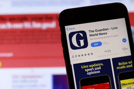 Los Angeles, California, USA - 26 November 2019: The Guardian icon on phone screen with logo on blurry background, Illustrative Editorial.のeditorial素材