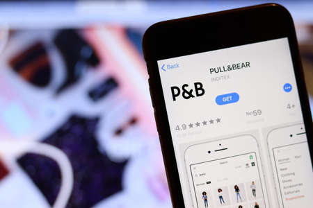 Los Angeles, California, USA - 26 November 2019: Pull and Bear icon on phone screen with logo on blurry background, Illustrative Editorial.のeditorial素材