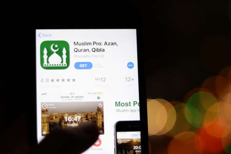 Los Angeles, California, USA - 28 November 2019: Muslim Pro app logo on mobile phone screen with blurry background, Illustrative Editorial.のeditorial素材
