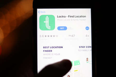 Los Angeles, California, USA - 28 November 2019: Loctra Find Location app logo on mobile phone screen with blurry background, Illustrative Editorial.のeditorial素材