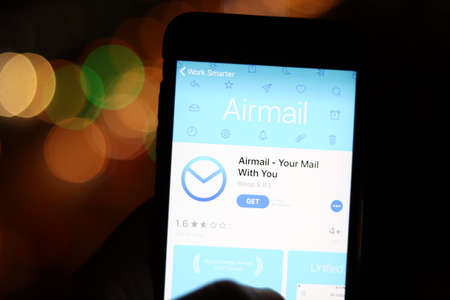 Los Angeles, California, USA - 28 November 2019: Airmail app icon on mobile phone screen with logo on laptop on blurry background, Illustrative Editorial.のeditorial素材