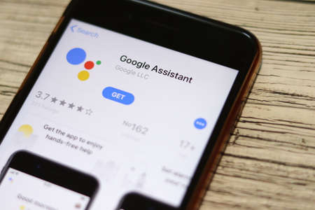 Phone with Google Assistant logo on screen top view close-up. Los Angeles, California, USA - 9 November 2019, Illustrative Editorial.のeditorial素材