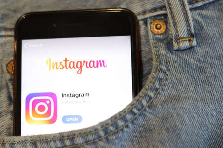 Phone with Instagram icon on screen in blue jeans pocket close-up. Los Angeles, California, USA - 30 November 2019, Illustrative Editorialのeditorial素材