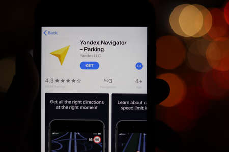 Phone with Yandex Navigator Parking icon on screen with blurry background. Los Angeles, California, USA - 30 November 2019, Illustrative Editorial.のeditorial素材