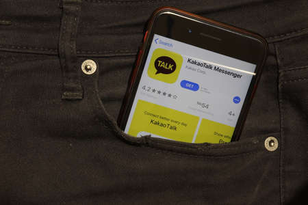 Saint-Petersburg, Russia - 6 December 2019: Mobile phone screen with KakaoTalk Messenger icon in pocket close-up, Illustrative Editorial.のeditorial素材