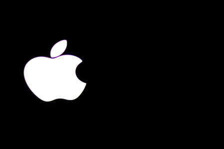 Saint-Petersburg, Russia - 10 December 2019: Apple brand sign logo on black background close-up with copy space, Illustrative Editorialのeditorial素材