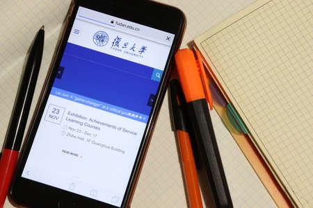 Los Angeles, California, USA - 7 December 2019: Mobile phone screen with Fudan University website page close-up. Higher education admission and overview concept, Illustrative Editorialのeditorial素材
