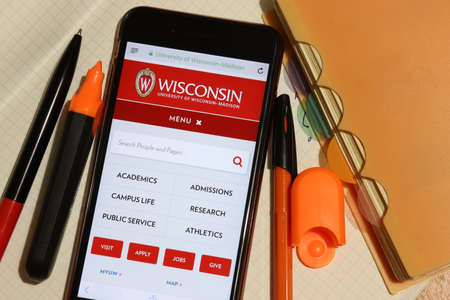 Los Angeles, California, USA - 7 December 2019: Mobile phone screen with University of Wisconsin-Madison website page close-up. Higher education admission and overview concept, Illustrative Editorial.のeditorial素材