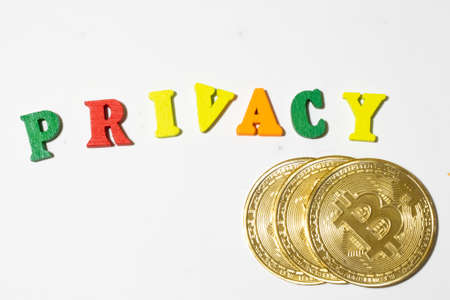 Privacy word made with letterboard and bitcoin coins on white background top view. Flat lay with copy space.の写真素材