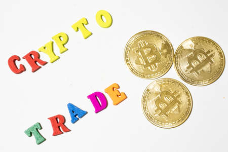 Word crypto trade with bitcoin on white background. Flat lay.の写真素材