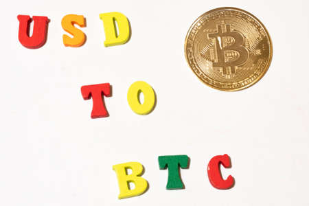 Usd to btc exchange concept with bitcoin cryptocurrency coin. Concept with letterboard.の写真素材