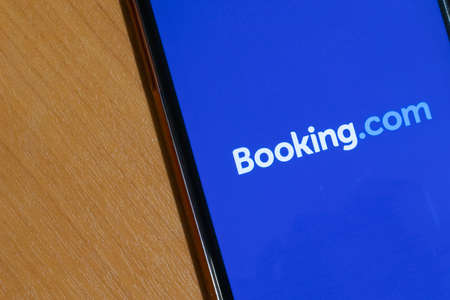 Saint-Petersburg, Russia - 10 January 2020: Booking app on phone screen close up with copy space. Booking.com blue logo, Illustrative Editorial.のeditorial素材