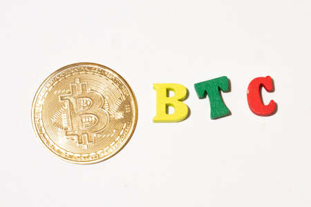 Bitcoin cryptocurrency for illustration, word btc with gold coin made with letterboard.の写真素材