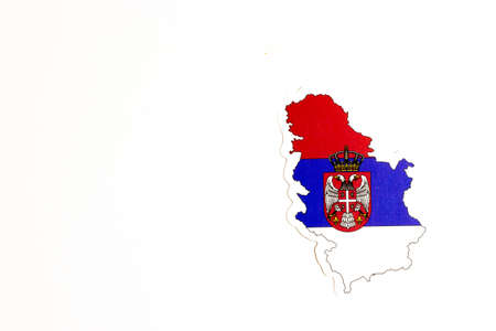 National flag of Serbia. Country outline on white background with copy space. Politics illustration.の写真素材