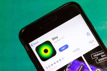 Los Angeles, California, USA - 22 January 2020: Sloy logo on phone screen flat lay with green...