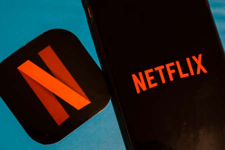 Los Angeles, California, USA - 22 January 2020: Netflix app logo and phone with icon close up on...