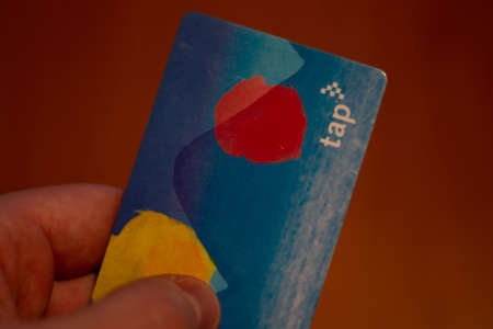 New York City, USA - 5 February 2020: TAP ride card in hand. Transit Access Pass LA. Los Angeles transport, Illustrative Editorial.のeditorial素材