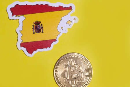 Spain Flag with Bitcoin flat lay for illustration. Cryptocurrency btc law concept.の写真素材