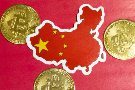 China Flag with Bitcoin flat lay for illustration. Cryptocurrency btc law concept.の写真素材