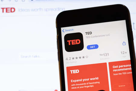 Los Angeles, California, USA - 12 February 2020: Mobile phone with TED icon on screen close up with website on laptop. Blurred background with TED.com site, Illustrative Editorial.のeditorial素材