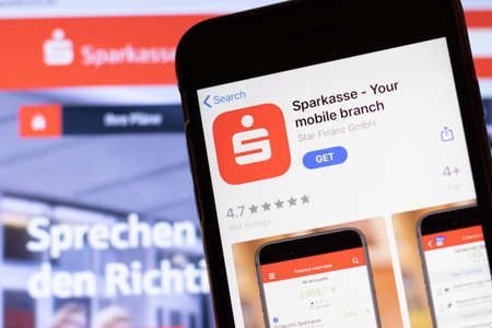 Los Angeles, California, USA - 12 February 2020: Mobile phone with Sparkasse icon on screen close up with website on laptop, Illustrative Editorial.のeditorial素材