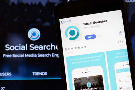 Los Angeles, California, USA - 12 February 2020: Mobile phone with Social Searcher icon on screen close up with website on laptop, Illustrative Editorial.のeditorial素材