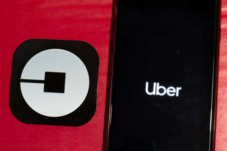 Los Angeles, California, USA - 12 February 2020: Uber app logo and phone with icon close up , Illustrative Editorial.のeditorial素材
