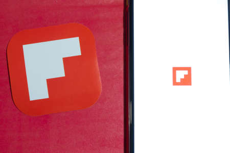 Los Angeles, California, USA - 12 February 2020: Flipboard app logo and phone with icon close up , Illustrative Editorial.のeditorial素材