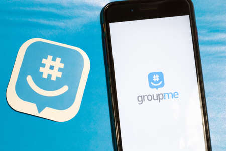 Los Angeles, California, USA - 12 February 2020: GroupMe app logo and phone with icon close up , Illustrative Editorial.のeditorial素材