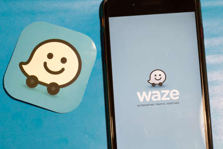 Los Angeles, California, USA - 12 February 2020: Waze app logo and phone with icon close up , Illustrative Editorial.のeditorial素材