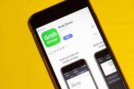 Los Angeles, California, USA - 12 February 2020: Grab Driver app icon on phone screen top view, Illustrative Editorial.のeditorial素材