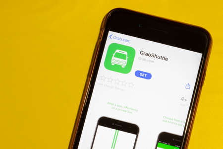 Los Angeles, California, USA - 12 February 2020: GrabShuttle app icon on phone screen top view, Illustrative Editorial.のeditorial素材