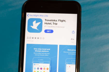 Los Angeles, California, USA - 12 February 2020: Traveloka app icon on phone screen top view, Illustrative Editorial.のeditorial素材
