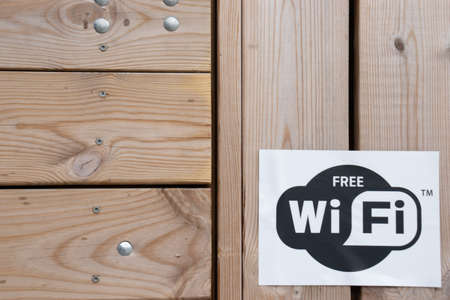 Helsinki, Finland - 3 March 2020: WiFi icon on wooden background , Illustrative Editorial.のeditorial素材
