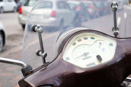 Close-up Steering wheel or handles of a scooter with a speed dial without a trademark. Street photo.の写真素材