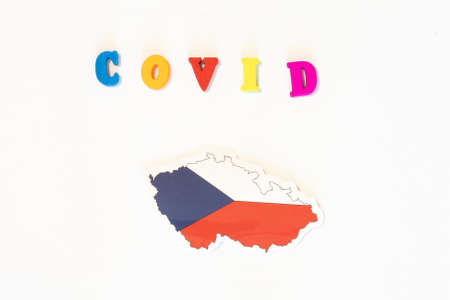 Czech Republic national flag on a white background with the inscription Covid made with letter board. Coronavirus is a pandemic virus.の写真素材