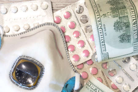Respirator with drug pills and tablets top view. Flat lay of money with copy space. Healthcare and pharmacology concept.の写真素材
