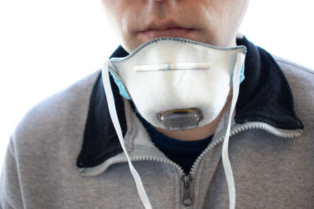 A man in a respirator on his neck. The man took off a medical mask. Close up shot. Health protection concept.の写真素材