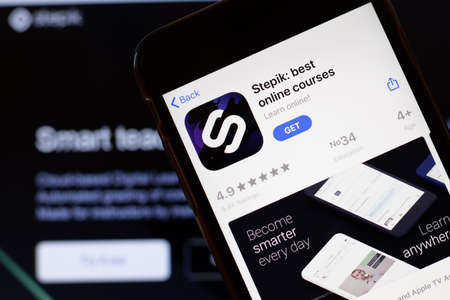 Los Angeles, California, USA - 24 March 2020: Stepik app logo on phone screen close up with website on background with icon, Illustrative Editorial.のeditorial素材