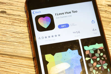 Los Angeles, California, USA - 24 March 2020: Top view of phone screen with I Love Hue Too logo icon on app store, Illustrative Editorial.のeditorial素材