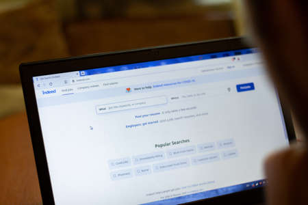 New York, USA - 9 April 2020: Indeed website on laptop screen close up. Man using service on display, blurry background, Illustrative Editorial.のeditorial素材