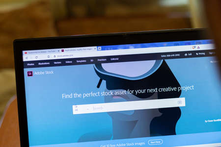 New York, USA - 9 April 2020: Adobe Stock website on laptop screen close up. Man using service on display, blurry background, Illustrative Editorial.のeditorial素材