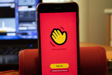 Los Angeles, California, USA - 16 April 2020: Houseparty logo on screen close up. App store icon visible on phone display, Illustrative Editorial.のeditorial素材