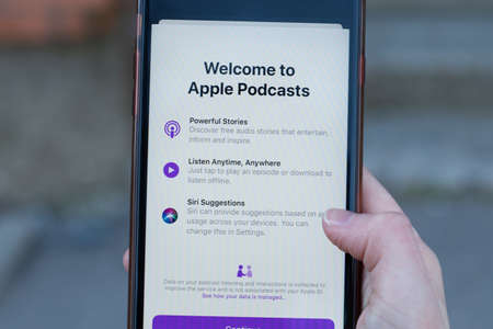 New York, USA - 1 May 2020: Apple Podcasts app logo close-up on phone screen, Illustrative...