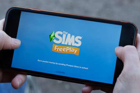 New York, USA - 1 May 2020: The Sims Free Play mobile game app logo close-up on phone screen,...