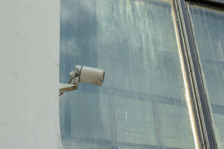 CCTV security camera on building wall outdoor. Urban street view